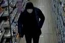 Police have released a CCTV image of a suspect in a robbery at a Co-op in Burgess Hill