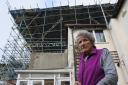 Jill Wilson wants a reduction in her council tax after living underneath scaffolding that has remained largely untouched for ten years
