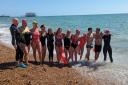 The team after finishing their swim. Frances is in the middle with the red cap and black swim costume (Image: Supplied)