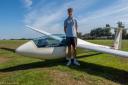 Aidan stands in front of the LS4B advanced glider he now flies regularly at Southdown Gliding Club