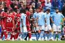 Manchester City's Rodri (centre right) looks dejected after being shown a red card for violent conduct by referee Anthony Taylor during the Premier League match at the Etihad Stadium. Image: PA