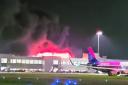 Flights have been grounded and Luton Airport closed amid a major blaze in a car park.