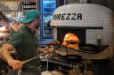 The pizzas are cooked in a classic oven at the back of the restaurant