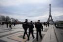 French gendarmes patrol the Trocadero plaza near the Eiffel Tower after a man targeted passersbys late Saturday, killing a German tourist with a knife and injuring a British man (Christophe Ena/AP)