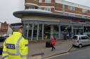 A police officer super-imposed on a photo of Tesco Express, Seaford