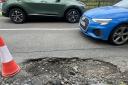 Motorist narrowly swerves 'artillery crater' sized pothole while driving