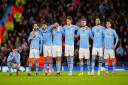 Manchester City players watch as their Champions League dream ends