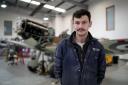 Alex Monk, Spitfire pilot and engineer at the Biggin Hill Heritage Hangar, with a Spitfire which is currently undergoing a full restoration at the airport in Kent (Gareth Fuller/PA Wire)
