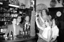 Does anyone recognise the venue or anybody from this picture of pub-goers and their charity penny tower in the 1960s?