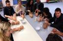 Class participants learn how to wash a baby using dolls