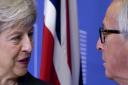 European Commission President Jean-Claude Juncker, right, greets British Prime Minister Theresa May at EU headquarters in Brussels, Wednesday, Nov. 21, 2018. British Prime Minister Theresa May meets with European Commission President Jean-Claude Juncker i