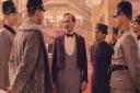 The back of Edward Norton and the fronts of Ralph Fiennes & Tony Revolori in The Grand Budapest Hotel...