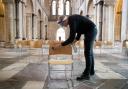 Senior Verger Luke Marshall cleans socially distanced chairs at Chichester Cathedral in West Sussex, as they prepare to reopen for public worship on 5th July, as further coronavirus lockdown restrictions are lifted in England. PA Photo. Picture date:
