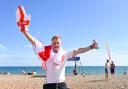 An England fan celebrates on Brighton beach in July 2021