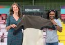 Artist Barbara Keal (left) and Lewes FC midfielder Bradley Pritchard (right) holding the as yet unpatched Coat of Hopes