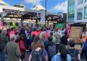 Protesters outside Brighton station held banners and signs before marching through the city
