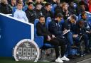 Ed Turns (white top) watches Brighton's defeat by Tottenham from the bench. Picture Simon Dack