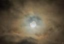 Clouds parted to allow a glimpse at the partial solar eclipse earlier this morning