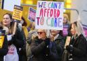 The pickets held up signs with slogans including 'We can't afford to care'