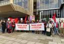 Protesters waved banners that said 'save our toilets' in protest of proposed cuts by the council