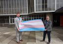 Councillors Phelim Mac Cafferty and Steph Powell with the trans pride flag outside Hove Town Hall
