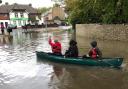 Sports students grabbed a canoe and rowed across a flooded road after yesterday's storm