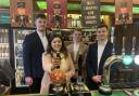 Three Acre Brewery directors Jamie Newton, left, Chester Broad, centre, and Peter Mayhew, with MP Nusrat Ghani as she pulls the first pint of their Session Pale at the Strangers' Bar