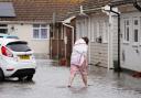 A person walking through floodwater in Littlehampton