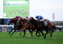 Crown Of Oaks ridden by Tom Marquand (right) on their way to winning the  Balmoral Handicap at Ascot