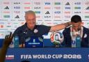 Diego Gomez is comforted by Paraguay head coach Gustavo Alfaro
