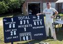 Ryan Welch next to the scoreboard after his 411