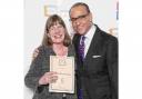 Steph Savill receives her winning certificate from Theo Paphitis