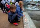 Youngsters place their candles on the Adur Ferry Bridge on Saturday night.  Picture: Liz Finlayson
