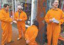 Band members dress in Guantanamo Bay-style prison suits to promote a benefit gig for Omar Deghayes