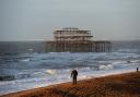 People walking near the West Pier on Brighton seafront as storms batter the coast.  Picture: Simon Dack.