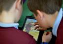 Youngsters use an iPad in a classroom