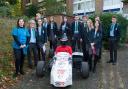 The teenagers from Oriel School and Seaford Head with the car that inspired them on a university visit