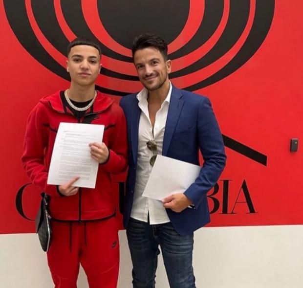 The Argus: Junior Andre and his dad Peter visited the Columbia offices with Rebel Records to sign the deal 