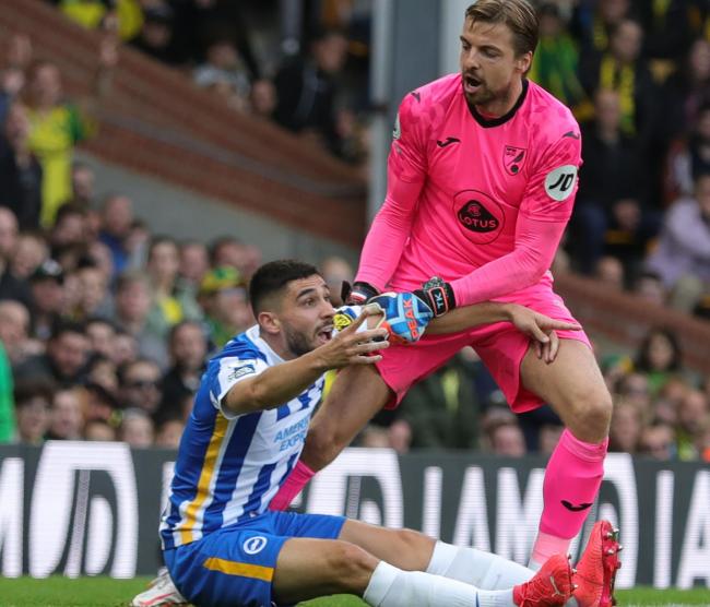Norwich City goalkeeper Tim Krul tries to lift Neal Maupay to his feet. Picture Richard Parkes