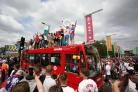 England fans climb aboard a bus outside the ground ahead of the UEFA Euro 2020 Final at Wembley Stadium, London. England have been ordered to play their next home UEFA competition match behind closed doors, with a further