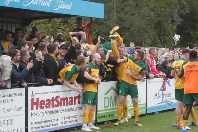 Horsham celebrate in style with fans after beating Woking in the FA Cup. Picture John Lines