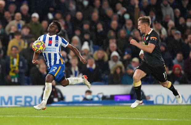 The Argus: Brighton and Hove Albion's Tariq Lamptey (left) and Newcastle United's Matt Ritchie battle for the ball during the Premier League match at the AMEX Stadium, Brighton. Picture date: Saturday November 6, 2021.