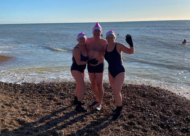 The Argus: Women and men sporting bikinis, shorts, wet suits, fancy dress and even a mankini took to the cold water in Hove to launch a Chrismas swim advent event.