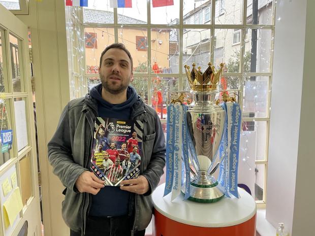 The Argus: Panini head of marketing Chris Clover and the Premier League trophy at Panini's launch at Fora in Brighton