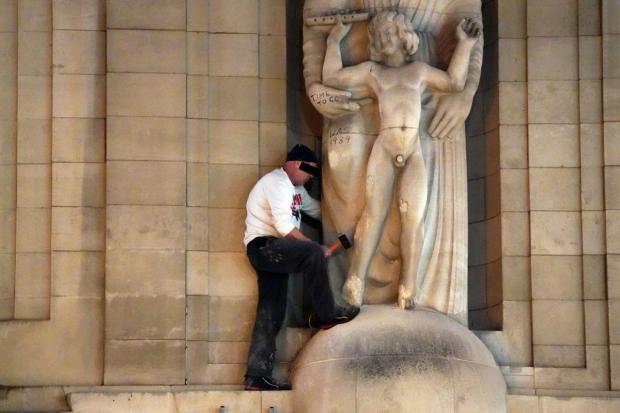 The Argus: Protester damaging a statue by Brighton-born paedophile artist Eric Gill 