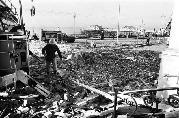 The Argus: A fireman walks amongst rubble the morning after the bombing: credit - Simon Dack