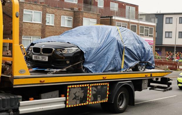 The Argus: The black BMW being taken from the scene
