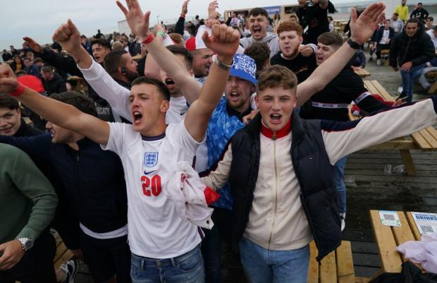 The Argus: England fans celebrating in a fan zone in Hastings 