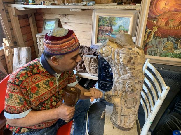 The Argus: Balavendra carving in his woodshop