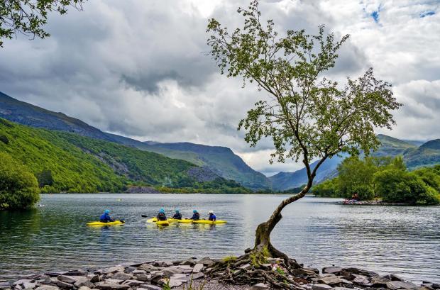 The Argus: Canoers on Llyn Padarn lake in Snowdonia. Picture: PA